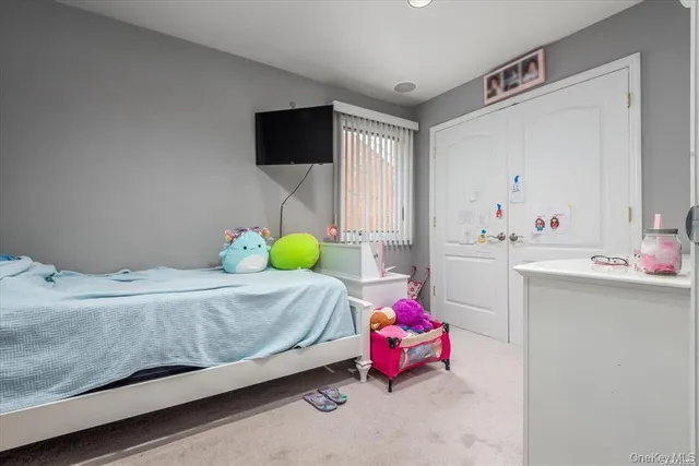 a bedroom with a bed a window and dresser