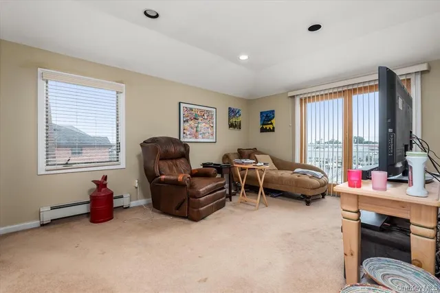 a livingroom with workspace and a window