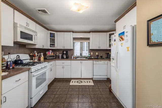 a kitchen with stainless steel appliances granite countertop a refrigerator and a stove