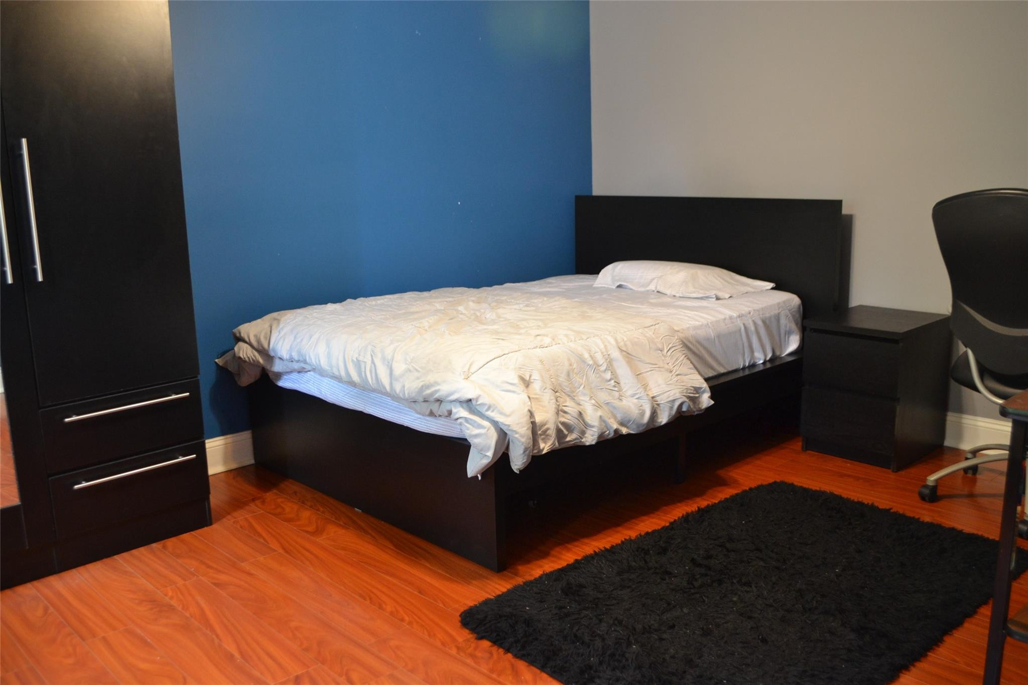 3539 Inverrary Boulevard West Lauderhill, FL 33319 - Photo 20 of 33 a bed sitting in a bedroom next to a window