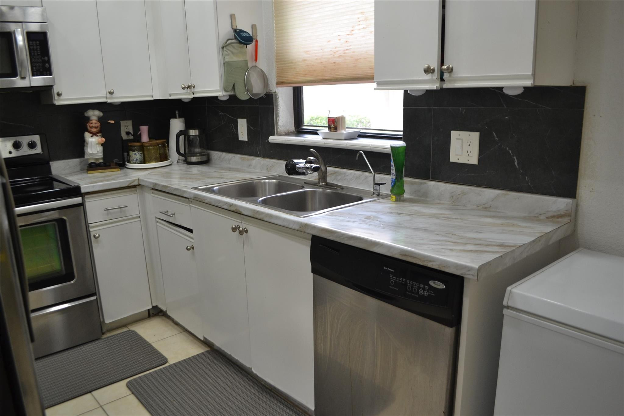 3539 Inverrary Boulevard West Lauderhill, FL 33319 - Photo 6 of 33 a kitchen with granite countertop a sink stove and cabinets