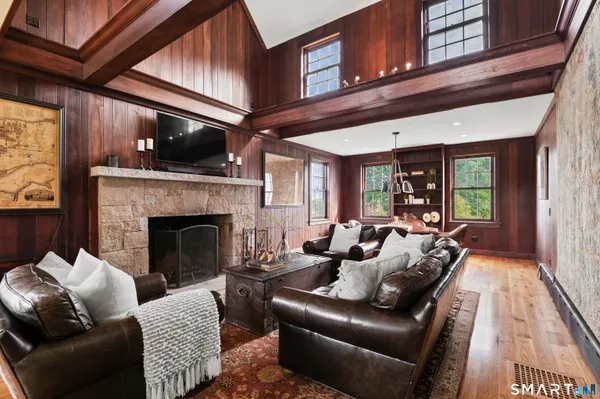 a living room with furniture a fireplace and a dining table