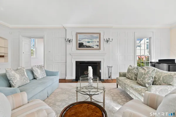 a view of a dining room with furniture a chandelier and wooden floor
