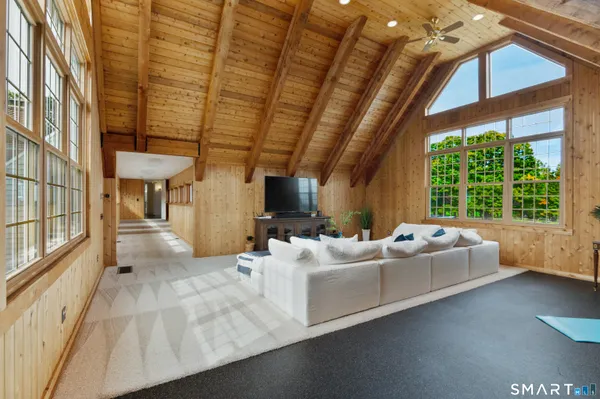 a bedroom with a bed wooden floor and window