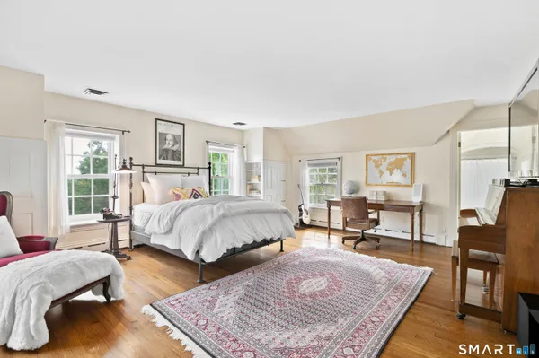 a spacious bathroom with a granite countertop sink and a mirror