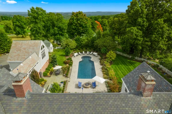 an aerial view of residential houses with outdoor space and lake view