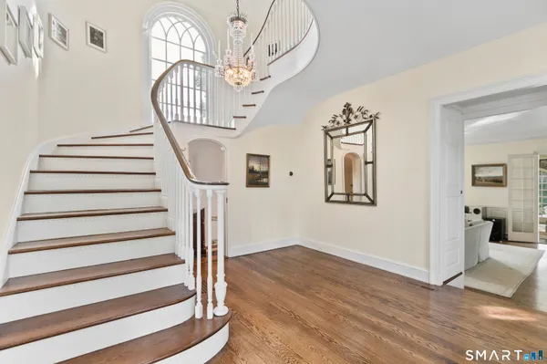 a view of entryway and hall with wooden floor