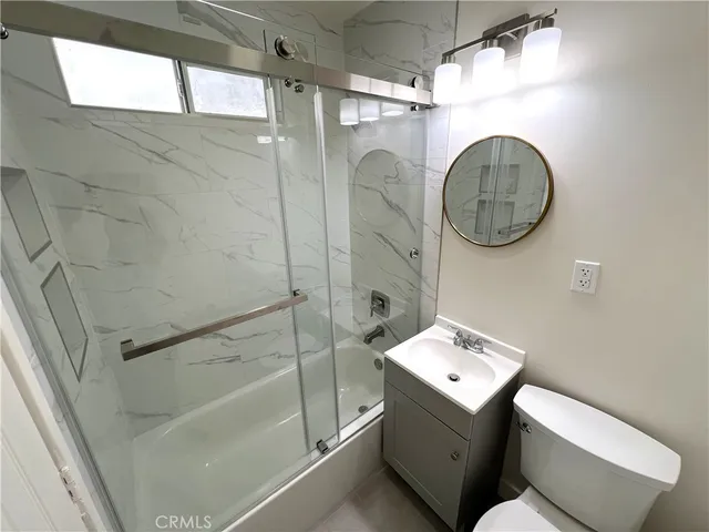 a bathroom with a toilet a sink and a shower