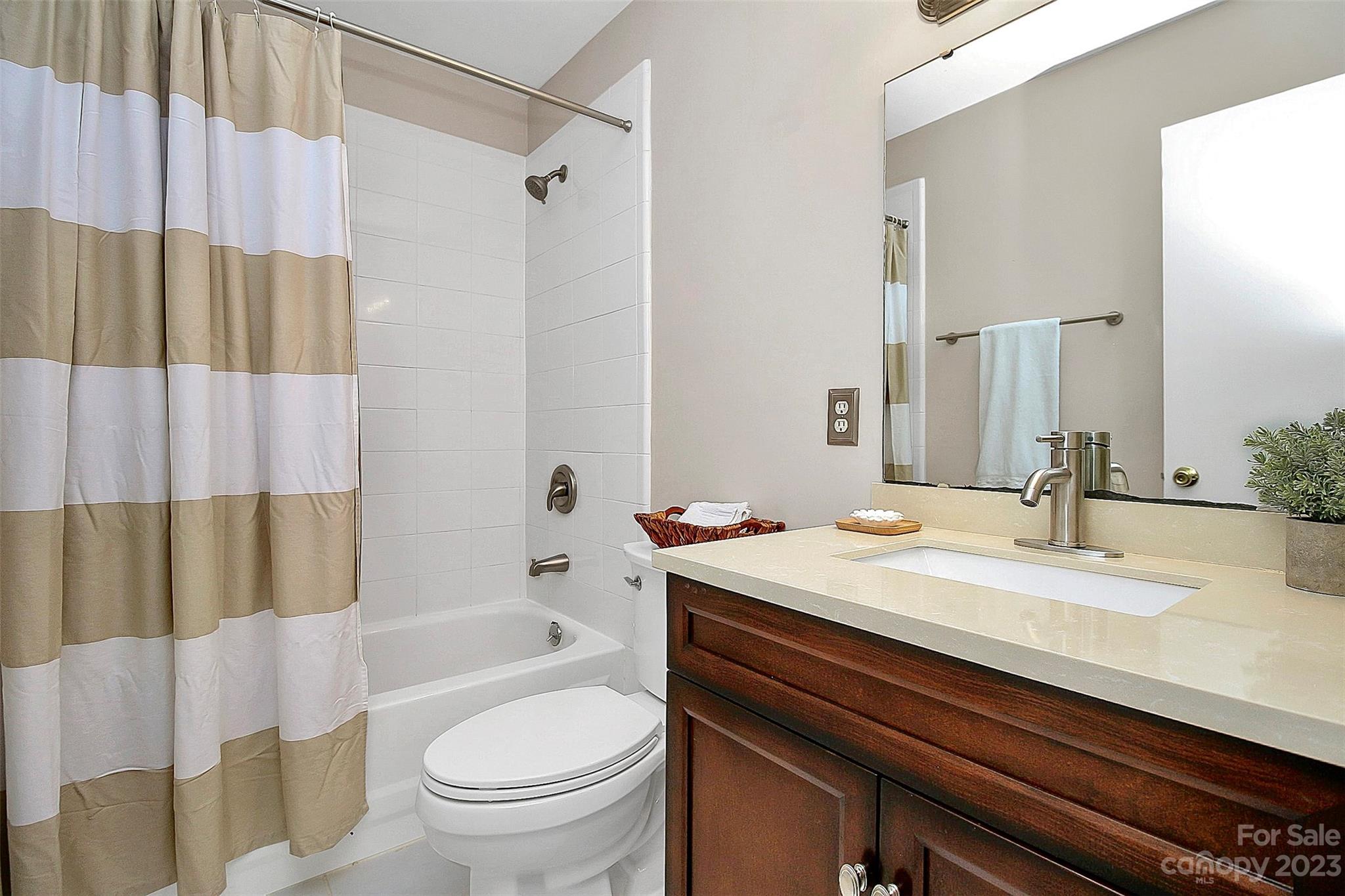 430 Queens Road, Unit 212 Charlotte, NC 28207 - Photo 10 of 23 a bathroom with a sink a toilet and a bathtub