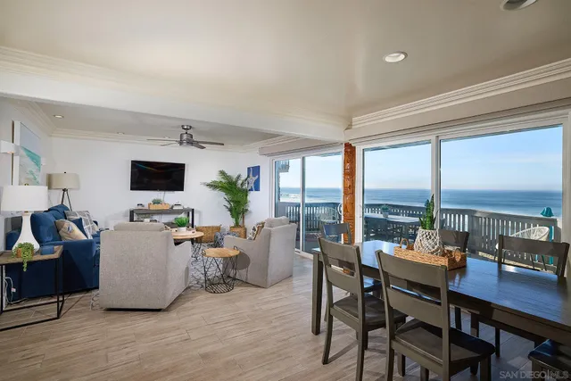 a living room with furniture a flat screen tv and a floor to ceiling window