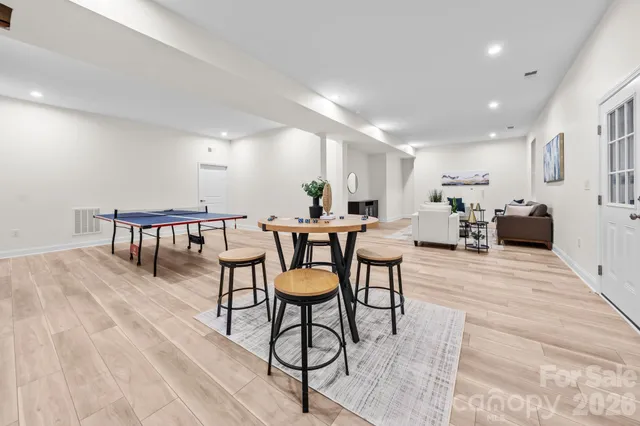 a dining room with furniture and wooden floor