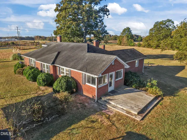 an aerial view of multiple houses with a yard