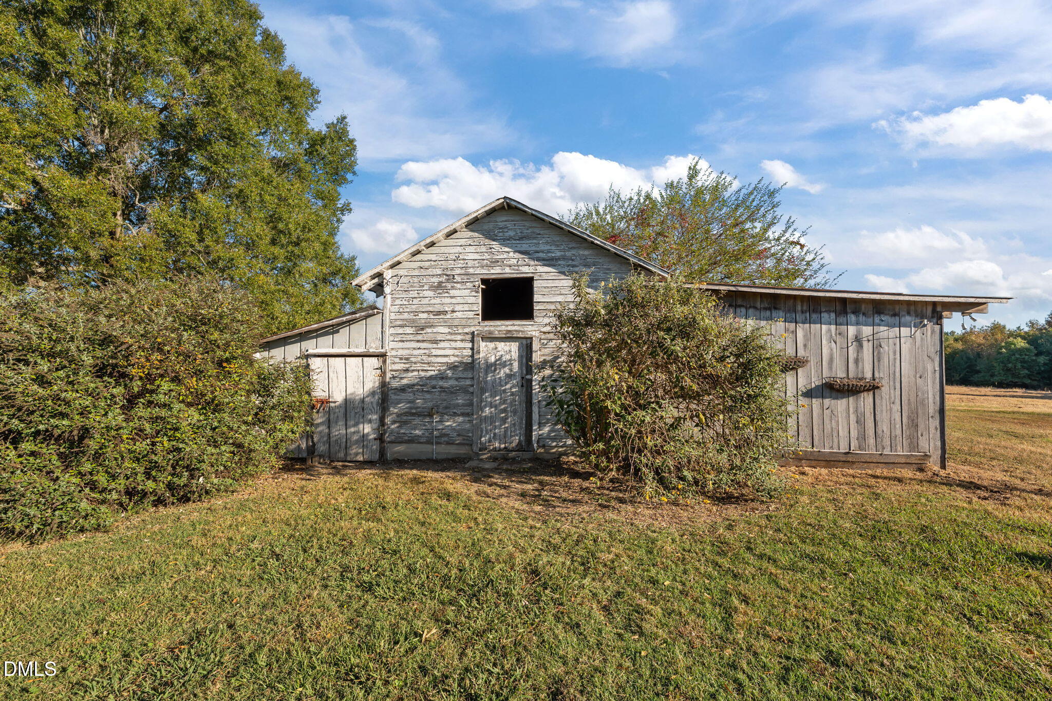 8794 Old 421 Road Julian, NC 27283 - Photo 8 of 24 a view of a house with a small yard plants and large tree