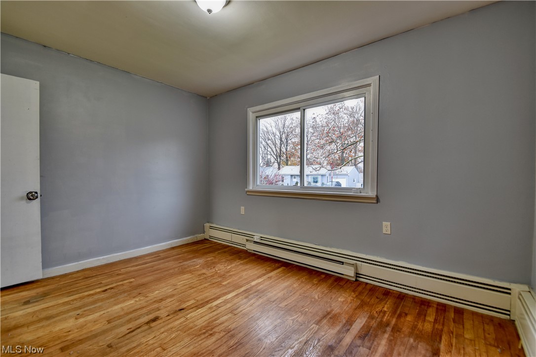 980 Reeve Road Elyria, OH 44035 - Photo 20 of 24 Spare room with baseboard heating and light hardwood / wood-style flooring
