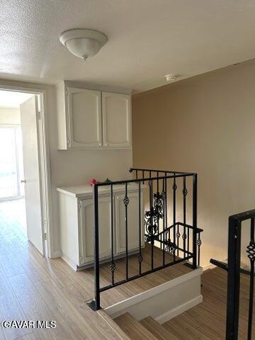 38710 10th Street East, Unit 12 Palmdale, CA 93550 - Photo 11 of 23 a view of staircase with wooden floor and window