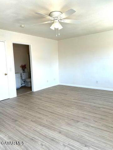 38710 10th Street East, Unit 12 Palmdale, CA 93550 - Photo 12 of 23 a view of a room with wooden floor and a ceiling fan