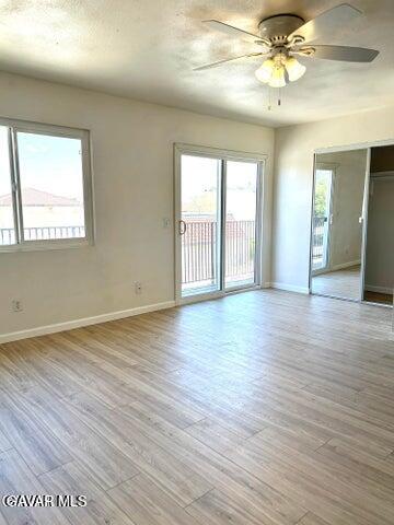 38710 10th Street East, Unit 12 Palmdale, CA 93550 - Photo 13 of 23 a view of an empty room with wooden floor and a window