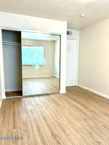 38710 10th Street East, Unit 12 Palmdale, CA 93550 - Photo 17 of 23 a view of an empty room with wooden floor