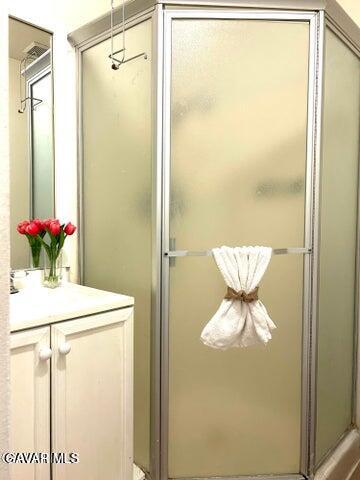 38710 10th Street East, Unit 12 Palmdale, CA 93550 - Photo 18 of 23 a bathroom with a granite countertop sink a toilet and a mirror