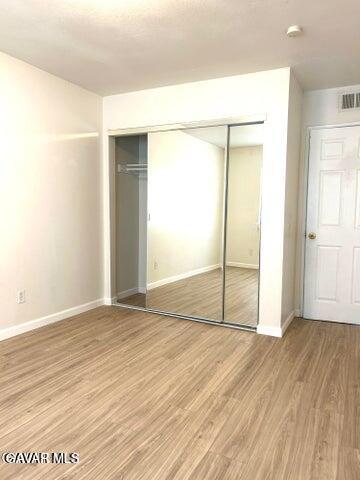 38710 10th Street East, Unit 12 Palmdale, CA 93550 - Photo 19 of 23 an empty room with wooden floor and a bathroom