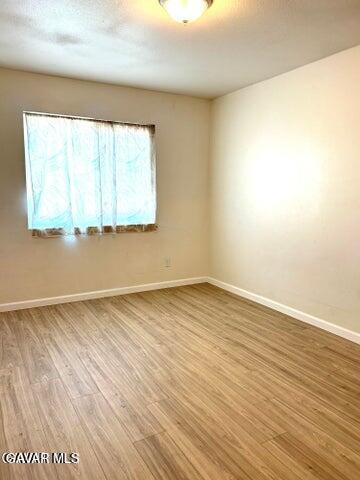 38710 10th Street East, Unit 12 Palmdale, CA 93550 - Photo 20 of 23 wooden floor in an empty room