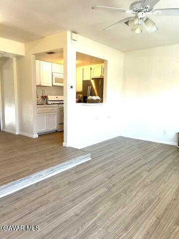 38710 10th Street East, Unit 12 Palmdale, CA 93550 - Photo 6 of 23 a view of a kitchen from the hallway with a sink