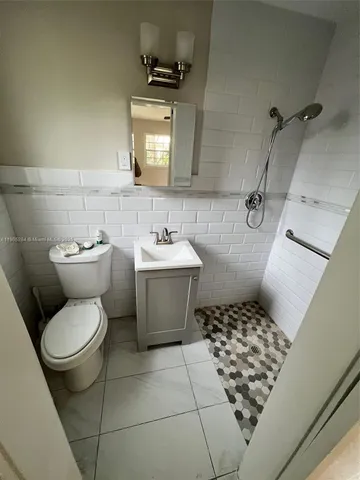 a bathroom with a sink toilet and mirror