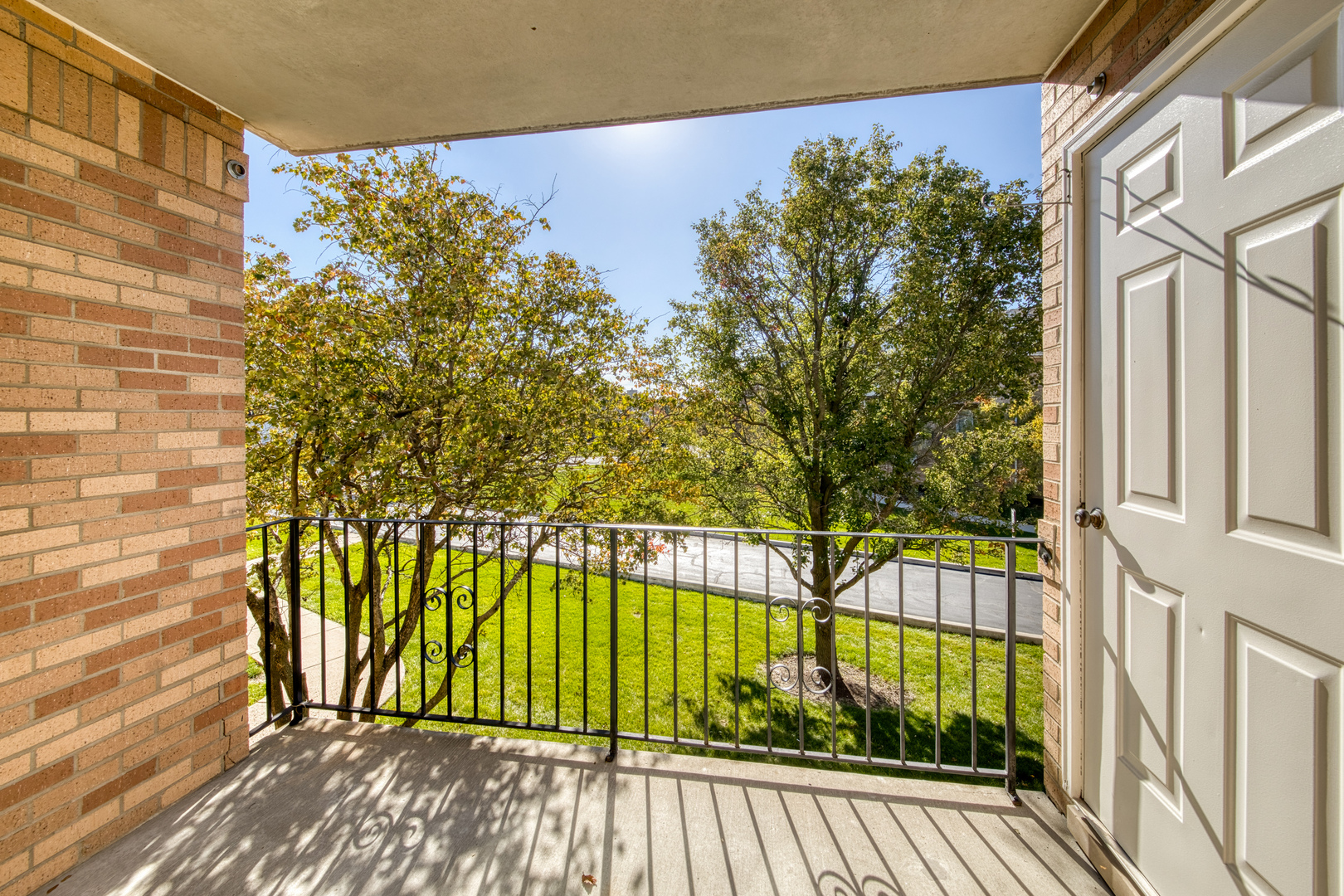 18310 Robin Lane, Unit D2 Homewood, IL 60430 - Photo 15 of 17 a view of a balcony with a floor to ceiling window and wooden fence