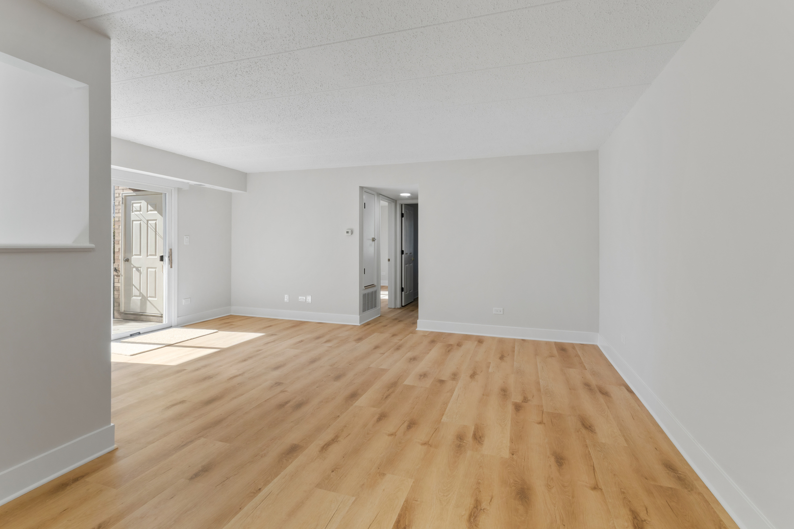 18310 Robin Lane, Unit D2 Homewood, IL 60430 - Photo 7 of 17 a view of empty room with wooden floor and fan