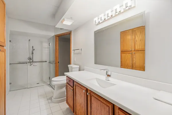 a bathroom with a sink a toilet and shower