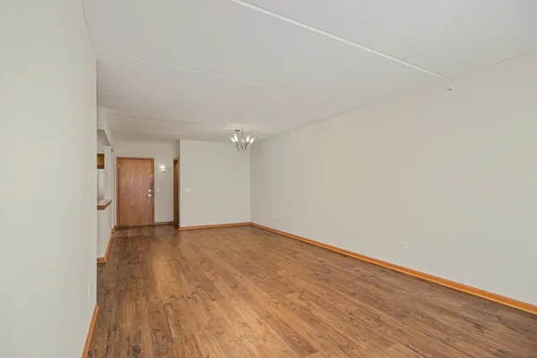 a view of an empty room and wooden floor