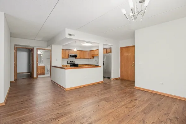 a view of kitchen with refrigerator and window