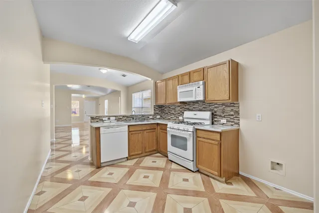 a kitchen with a stove and a sink