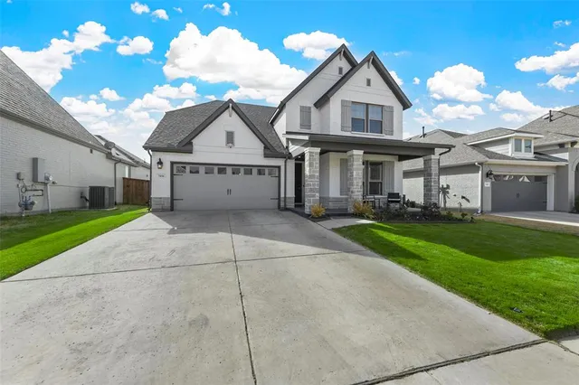 a view of a big house with a big yard and large trees
