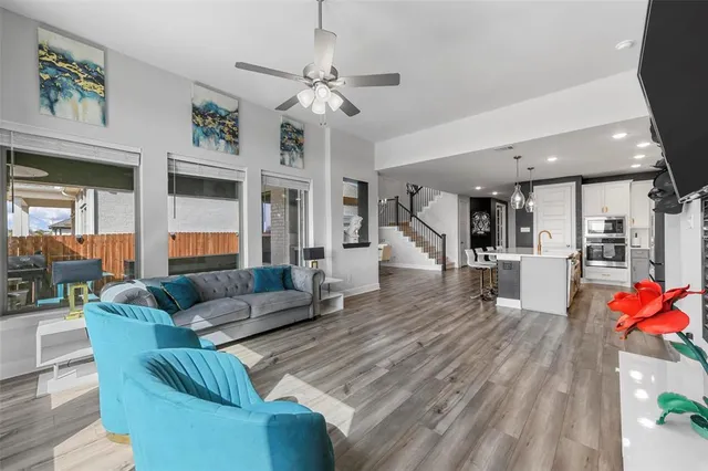 a living room with furniture and a chandelier