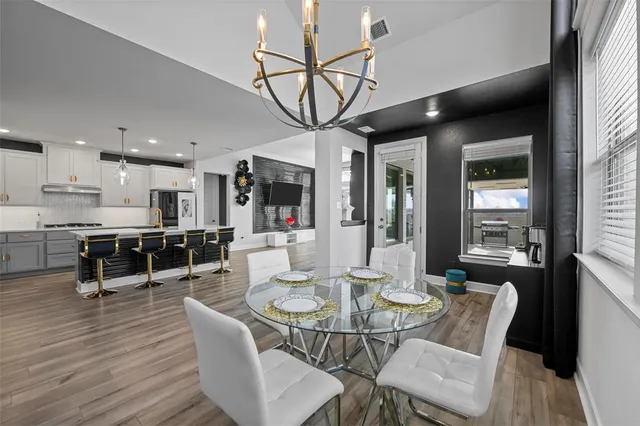 a view of a dining room with furniture window and wooden floor