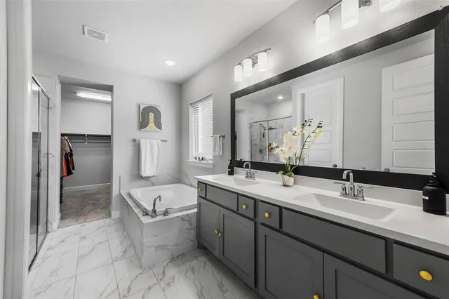 a spacious bathroom with a double vanity sink mirror and double