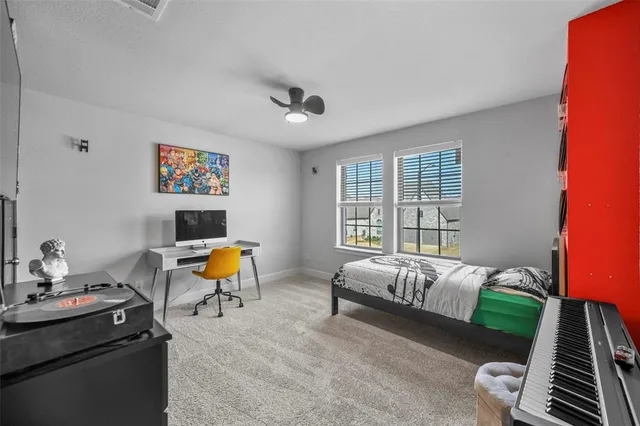 a bed room with a bed and a chair