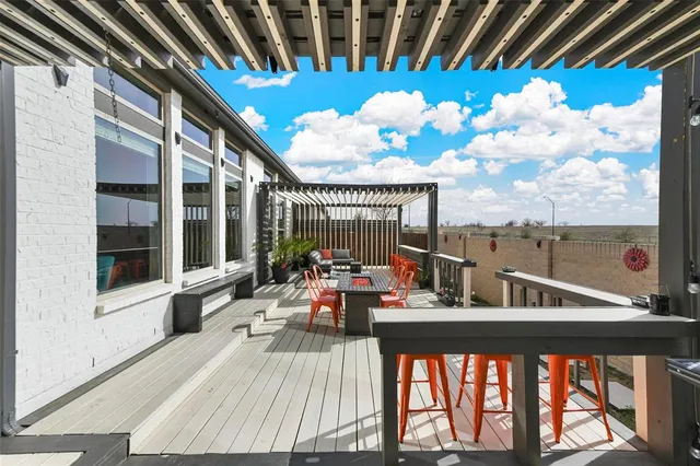 a view of a balcony with furniture and floor to ceiling window
