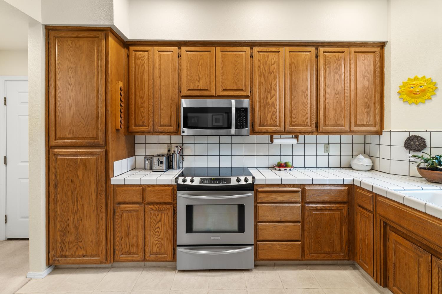 1153 Copper Lantern Court Modesto, CA 95355 - Photo 11 of 37 a kitchen with a stove and a sink