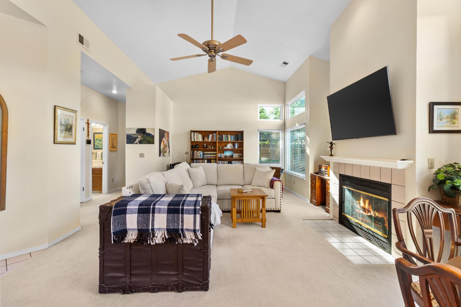 1153 Copper Lantern Court Modesto, CA 95355 - Photo 14 of 37 a living room with furniture a fireplace and a flat screen tv