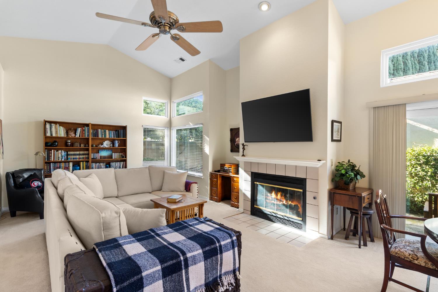 1153 Copper Lantern Court Modesto, CA 95355 - Photo 15 of 37 a living room with furniture a fireplace and a flat screen tv