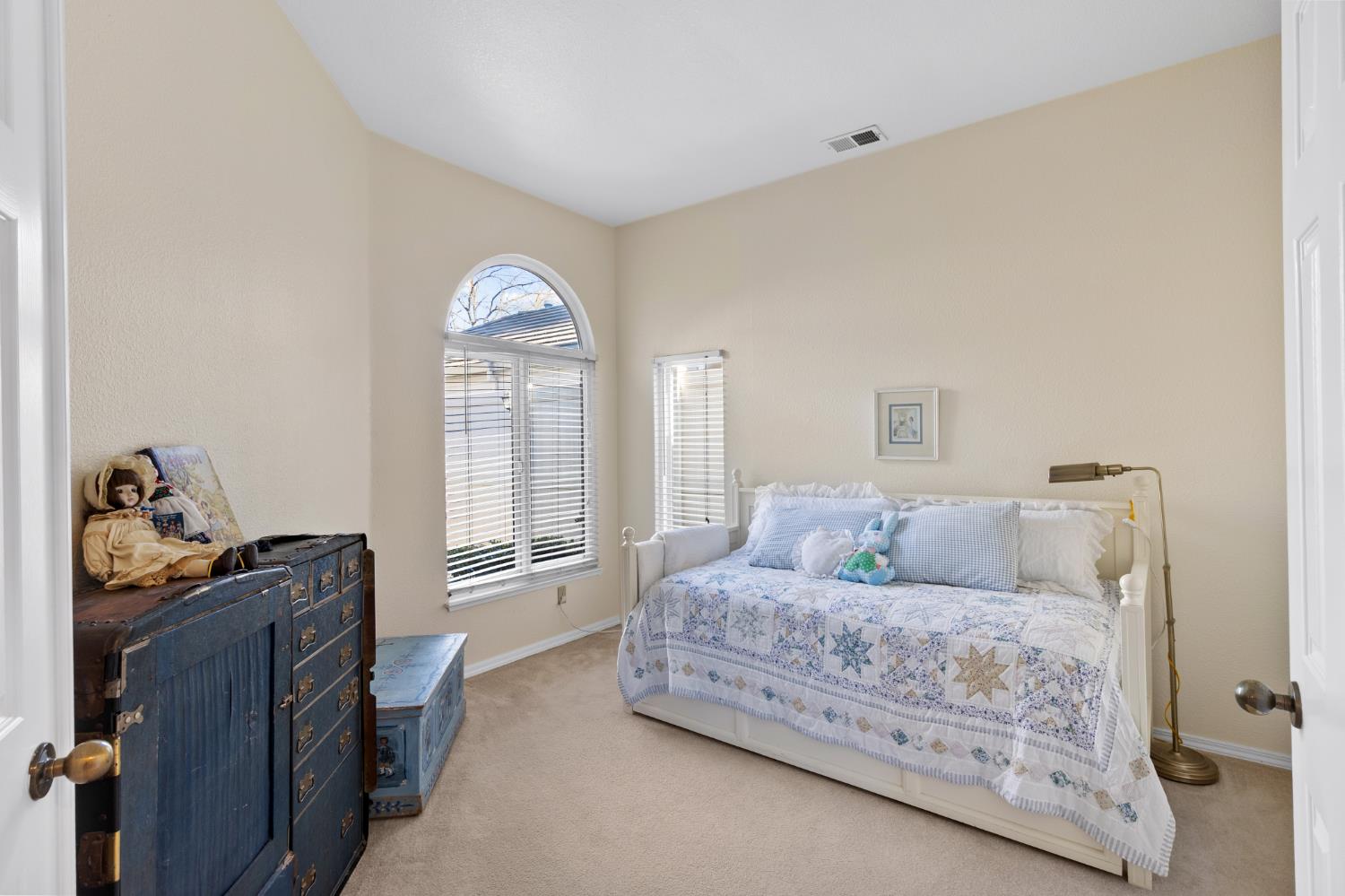 1153 Copper Lantern Court Modesto, CA 95355 - Photo 19 of 37 a bedroom with a bed and a chandelier