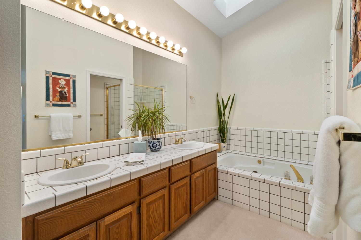 1153 Copper Lantern Court Modesto, CA 95355 - Photo 24 of 37 a bathroom with a bathtub sink and mirror