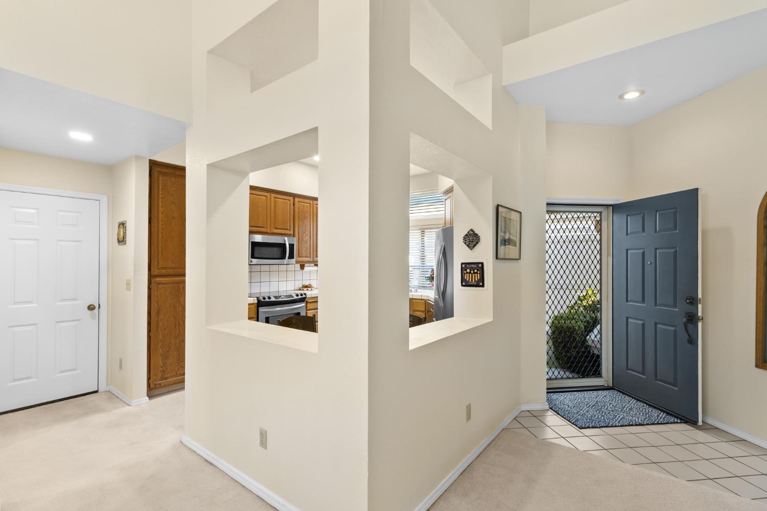 1153 Copper Lantern Court Modesto, CA 95355 - Photo 8 of 37 a view of a hallway with bathroom and wooden floor