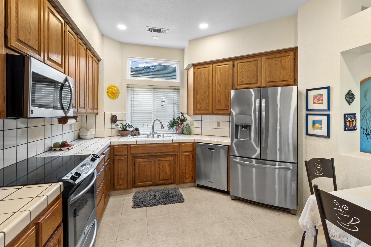 1153 Copper Lantern Court Modesto, CA 95355 - Photo 10 of 37 a kitchen with stainless steel appliances granite countertop a refrigerator stove and sink