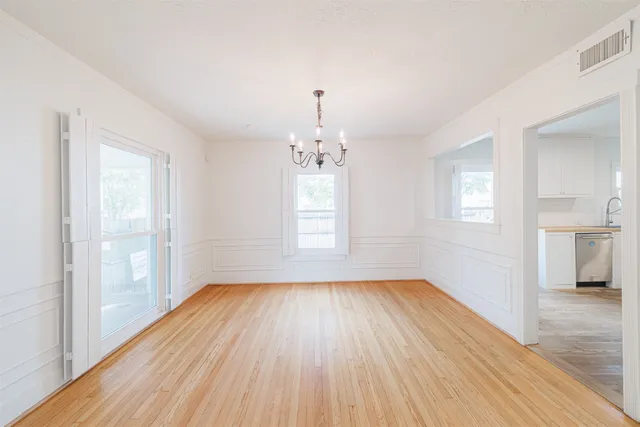 a view of a dining room with furniture and chandelier