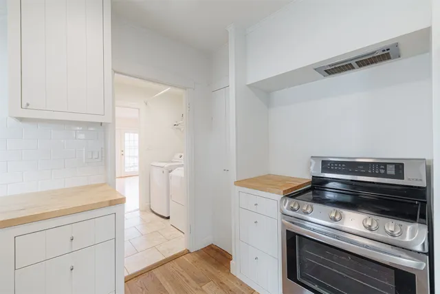 a kitchen with a sink a refrigerator and cabinets