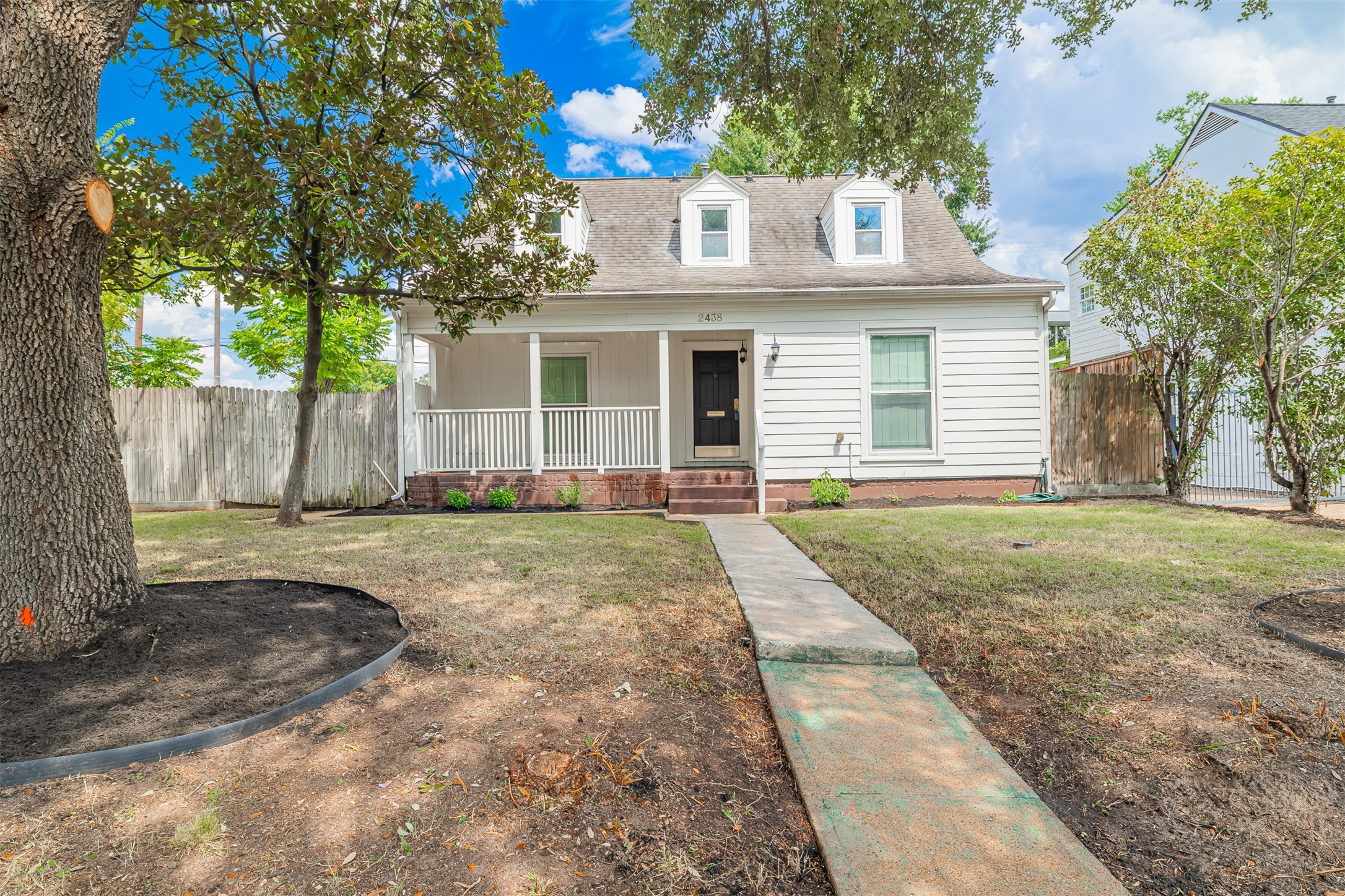 2438 Albans Road Houston, TX 77005 - Photo 2 of 34 a front view of a house with a yard and garage