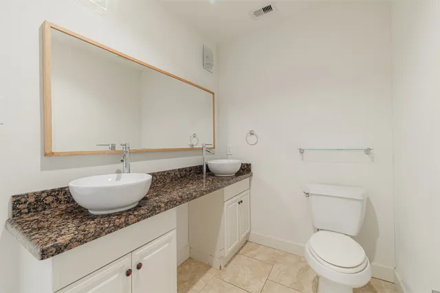 a bathroom with a toilet a sink and a shower